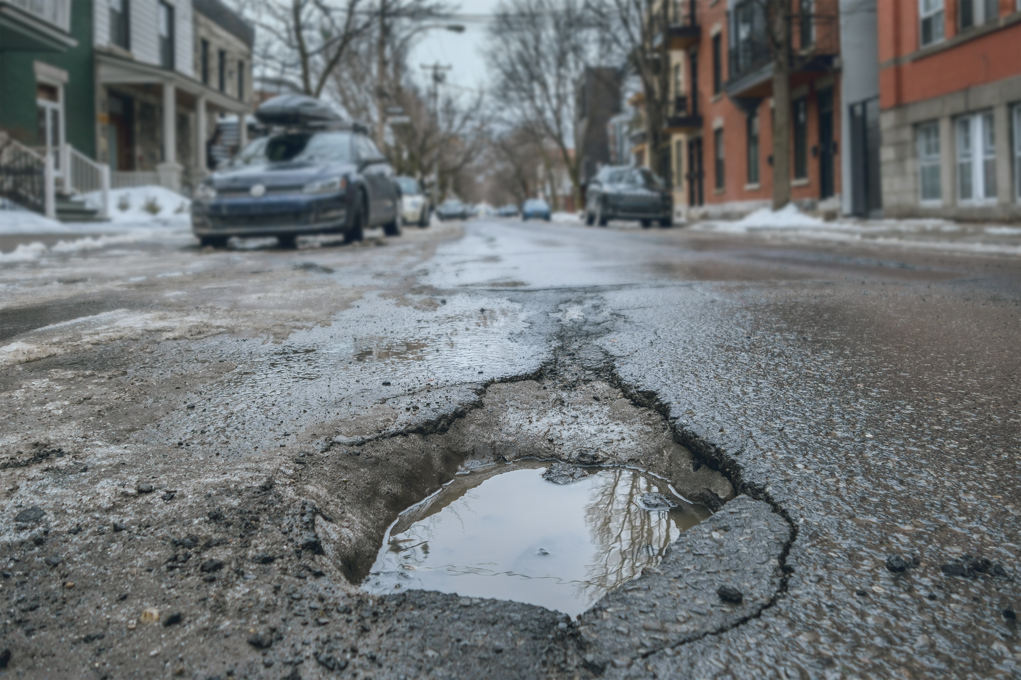 Close up of large pothole on city street.