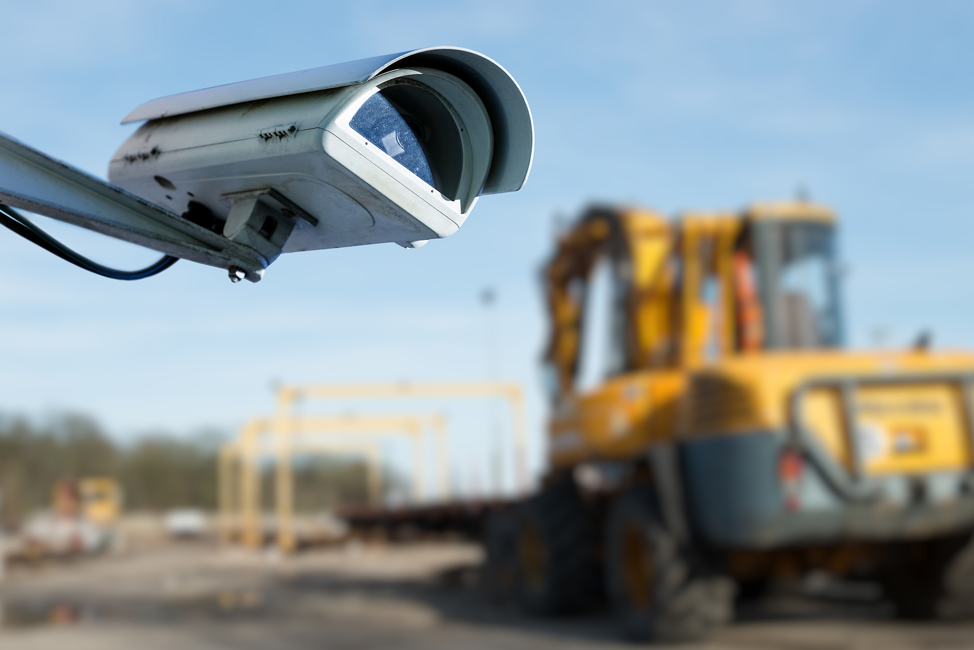 Close up of a security camera overlooking a construction site.