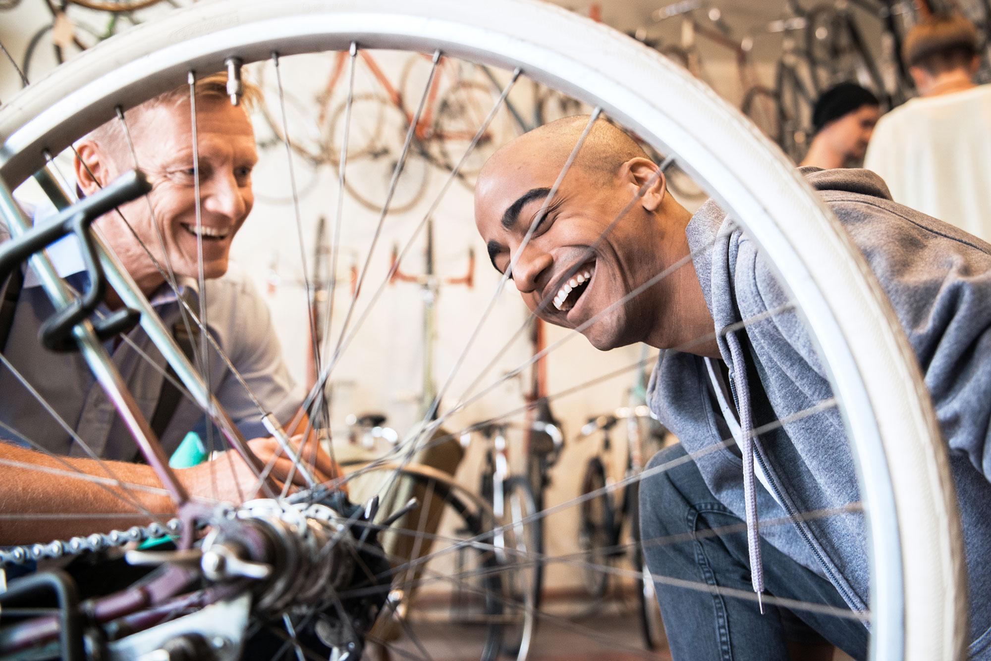 Customer and bicycle shop employee examining a bicycle together.