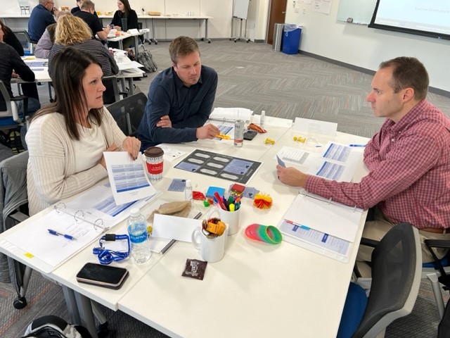 Photo of employees working together at a training session